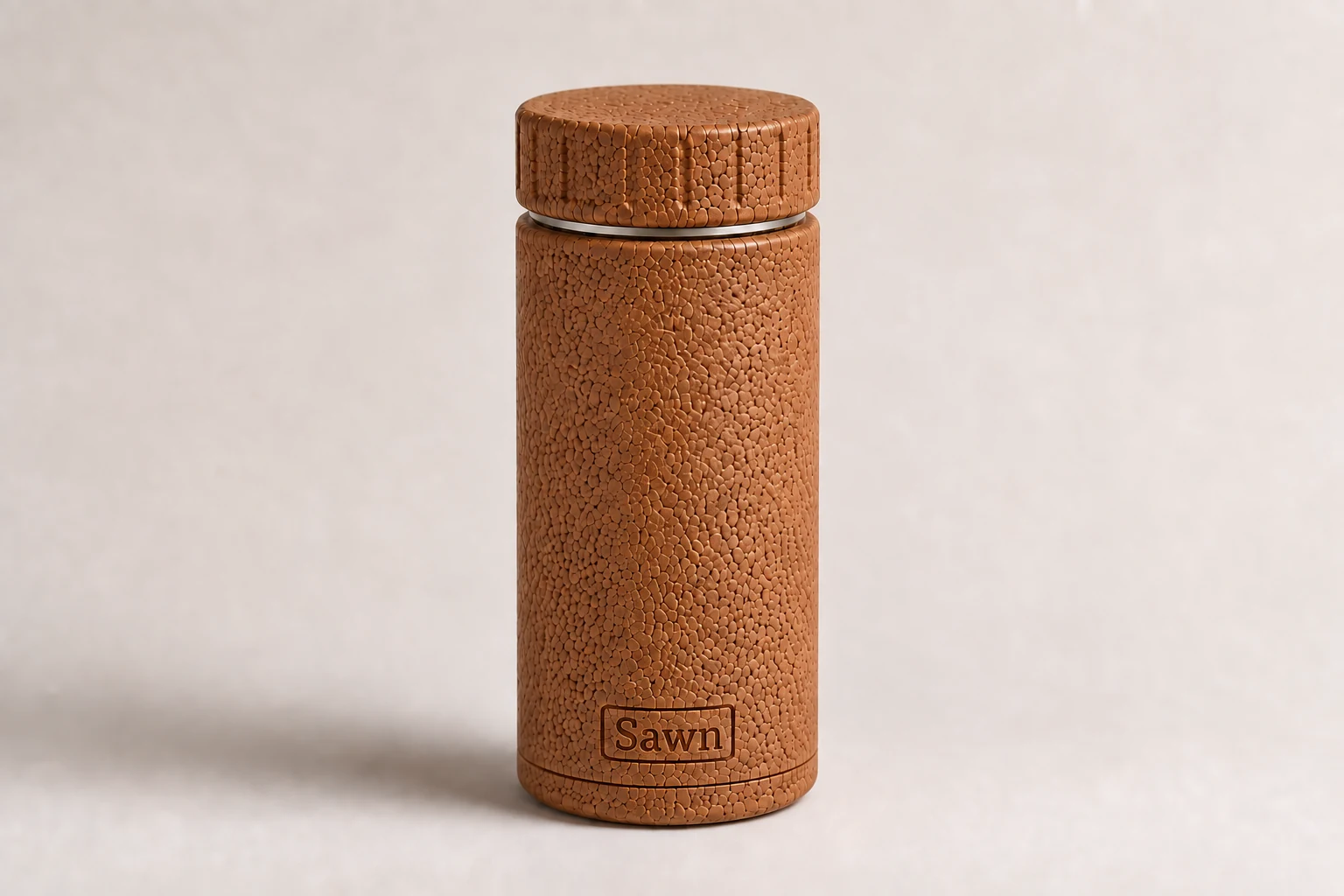 The Sawn bottle: sealed cork body, cork screw lid, a thin band of steel at the neck